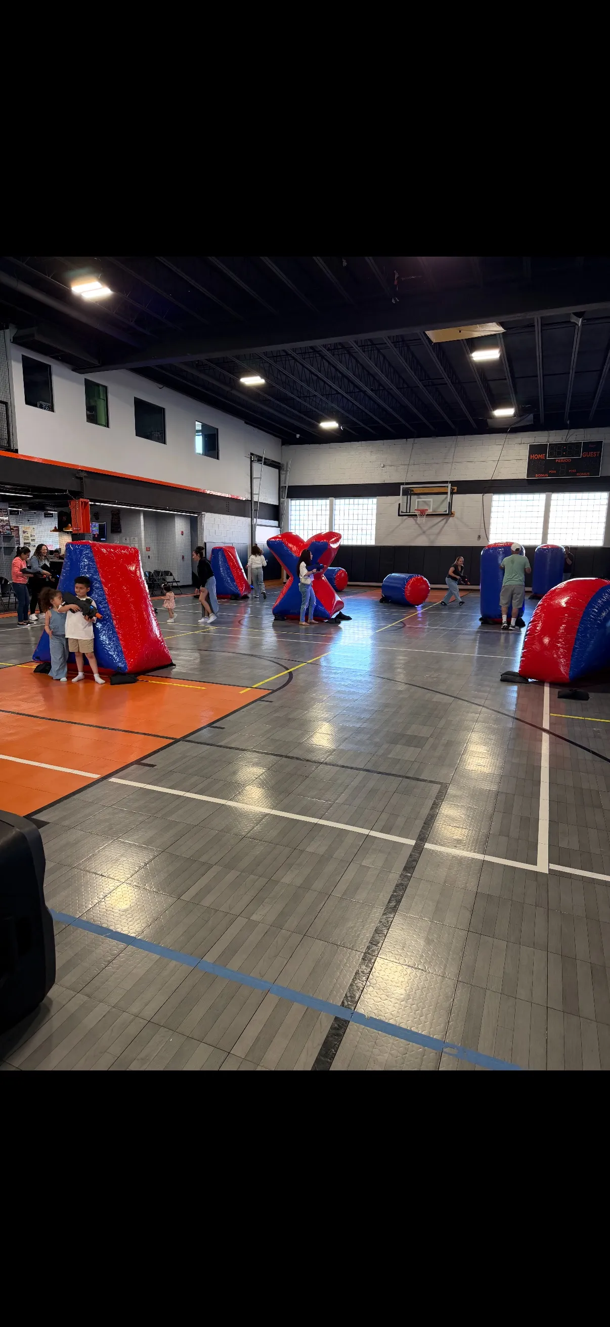 Players in laser tag battle with inflatable bunkers