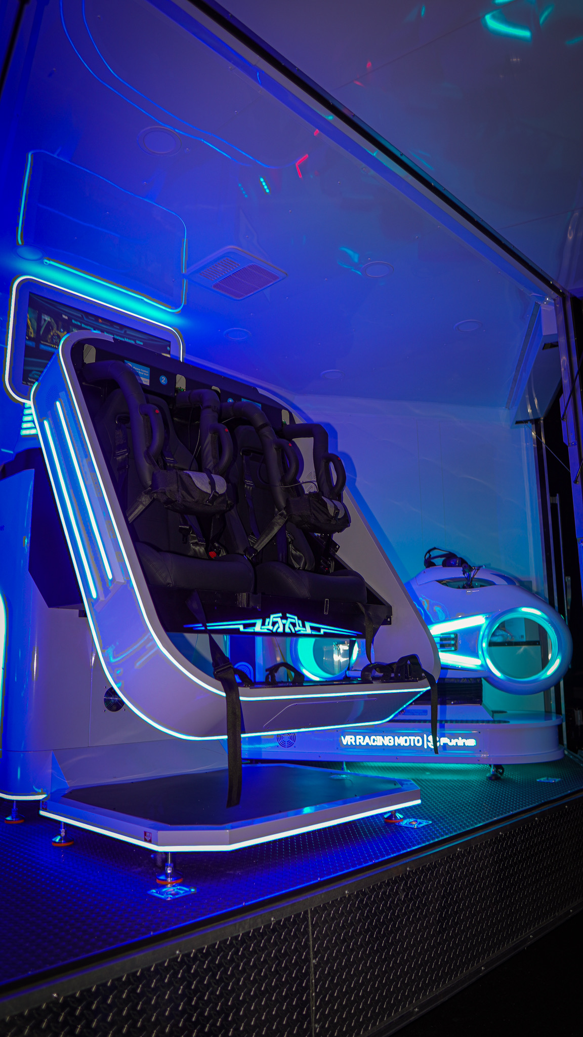VR cinema motion seats group ride with VR Racing Moto visible in background