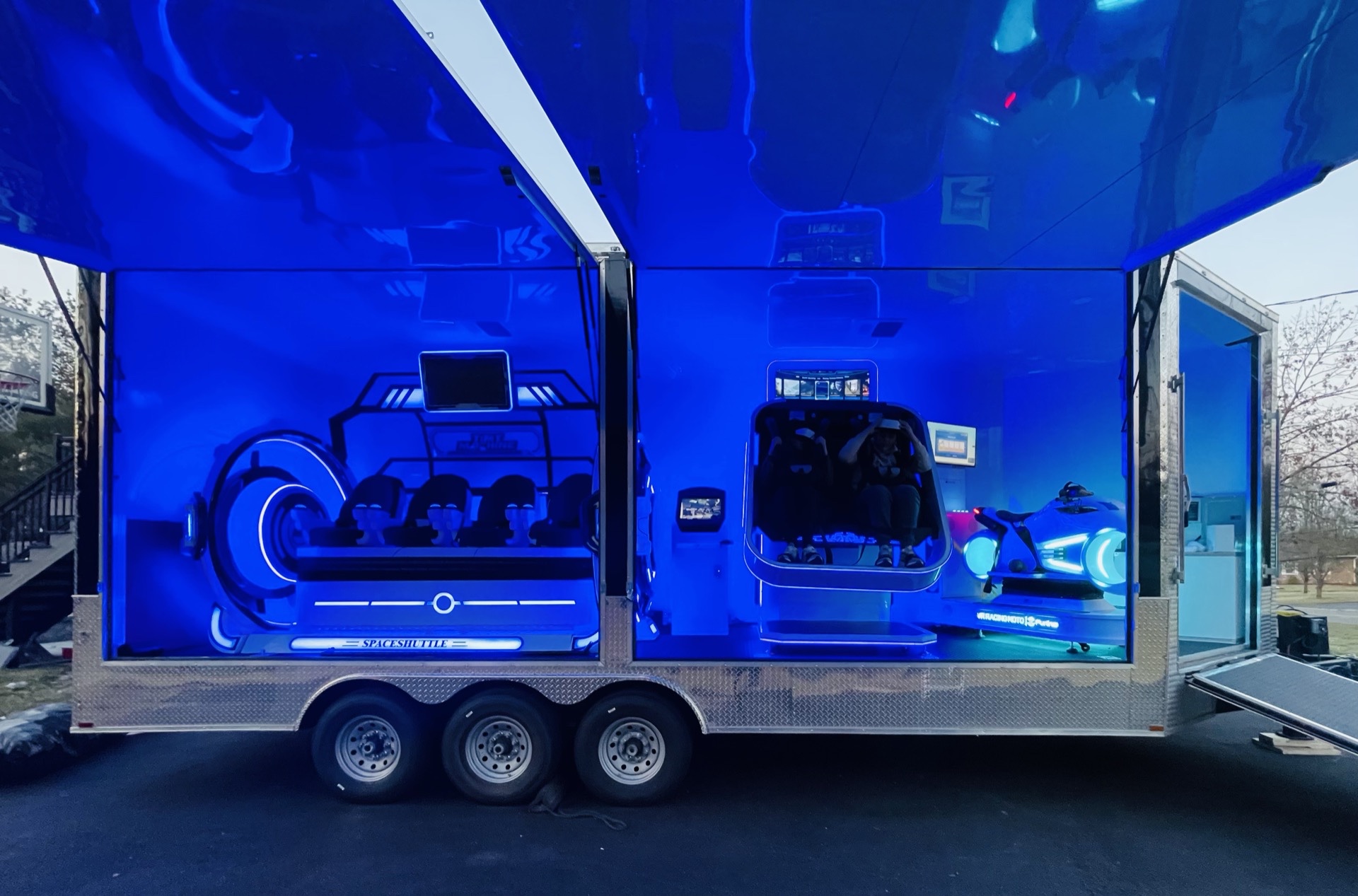VIP Virtual Thrills trailer fully open showing Space Shuttle cinema seats and VR Racing Moto side by side
