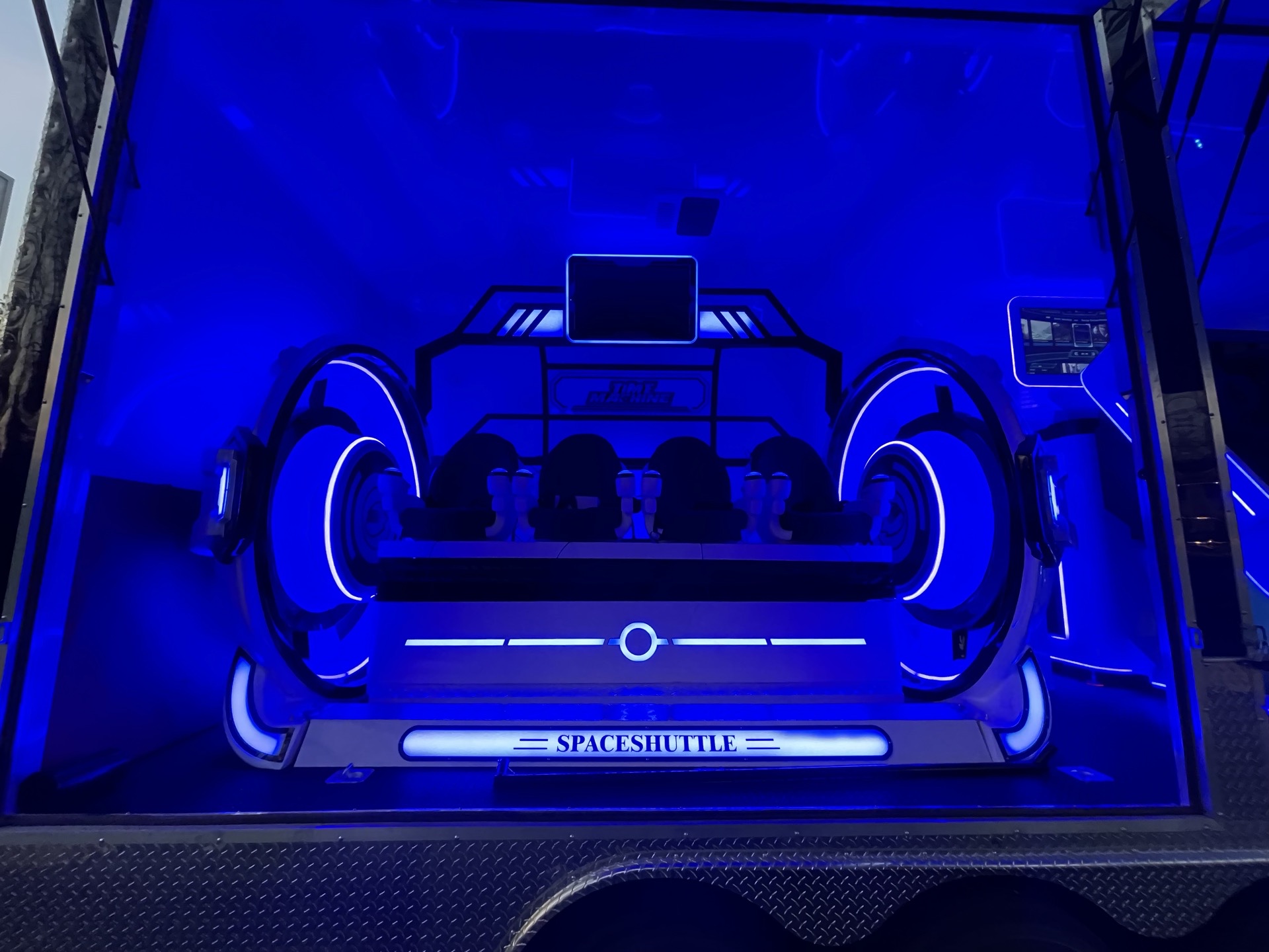 Front exterior of VIP Virtual Thrills trailer showing Space Shuttle cinema ride with blue lighting